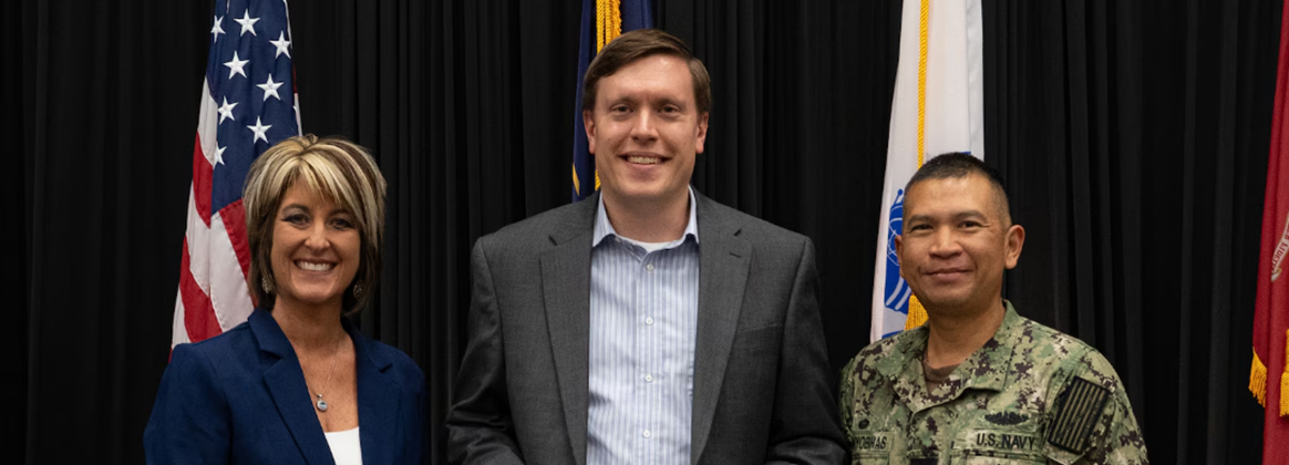 NSWC Crane engineer, Alexander Ray, pictured receiving the CSAM.